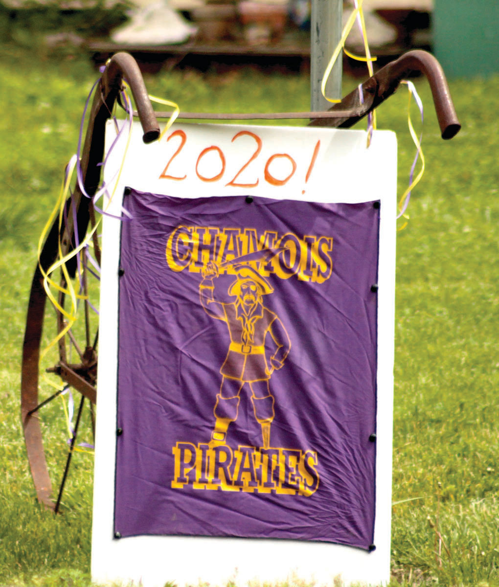 A sign in support of 2020 Chamois graduates is seen along the route taken Friday.